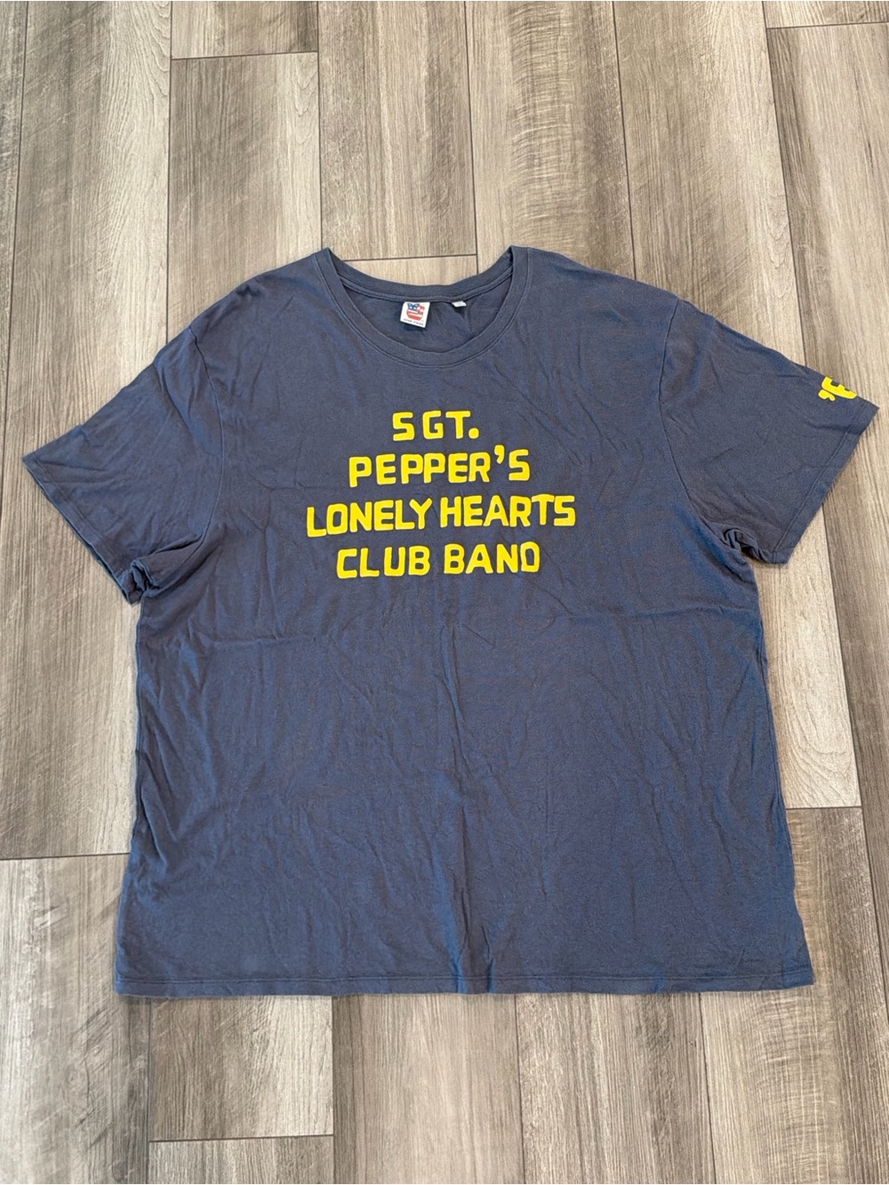 Junk Food Clothing Navy T‑Shirt with Yellow Sgt. Pepper's Graphic